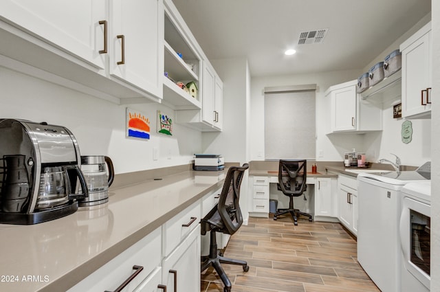 office area with sink, washer and dryer, light hardwood / wood-style flooring, and built in desk