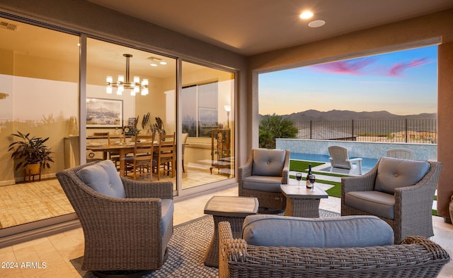 patio terrace at dusk featuring an outdoor hangout area and a mountain view