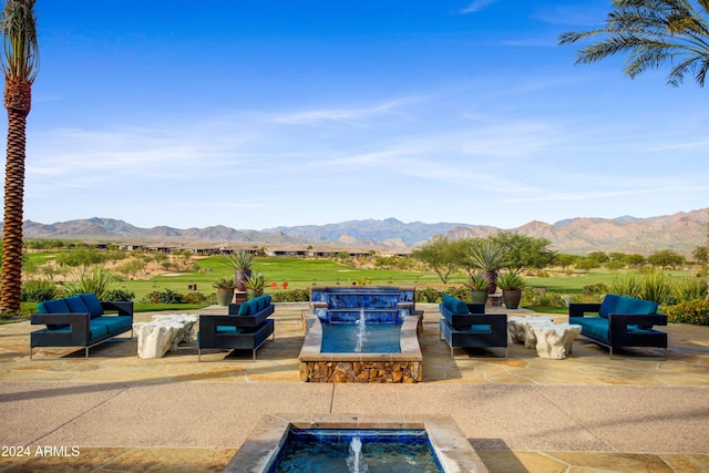 view of pool with a mountain view, pool water feature, and a patio area