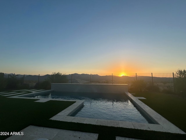 view of pool at dusk