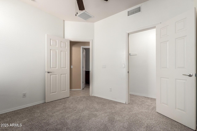 15588 W Devonshire Ave, Goodyear, AZ 85395 - unfurnished bedroom with carpet floors, a walk in closet, and a ceiling fan