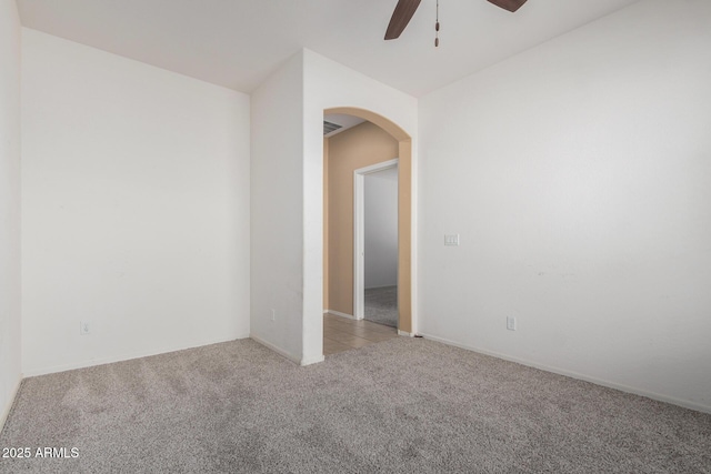 15588 W Devonshire Ave, Goodyear, AZ 85395 - spare room with light carpet, arched walkways, and a ceiling fan