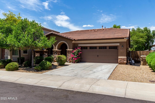 15588 W Devonshire Ave, Goodyear, AZ 85395 - view of front of home with a garage, a tile roof, stucco siding, driveway, and stone siding
