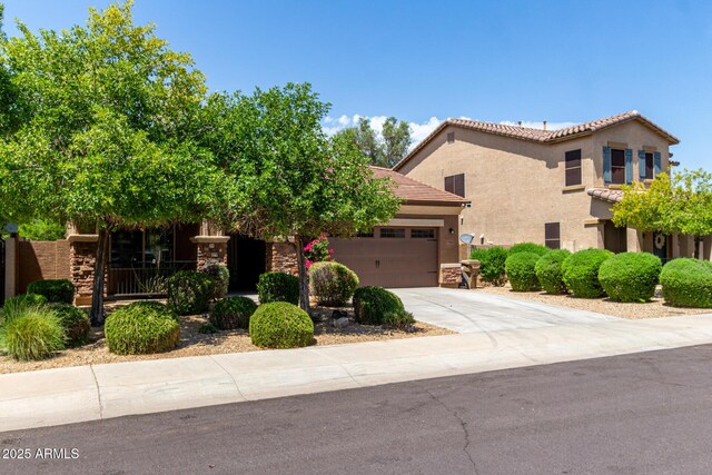 15588 W Devonshire Ave, Goodyear, AZ 85395 - view of front of property featuring driveway, a garage, stucco siding, and a tiled roof