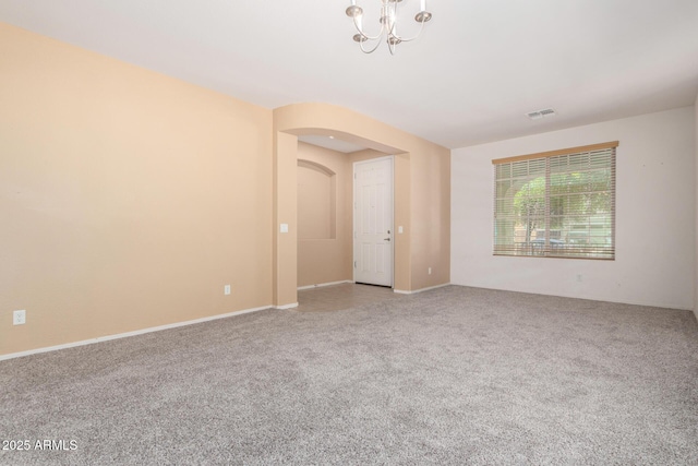 15588 W Devonshire Ave, Goodyear, AZ 85395 - carpeted spare room featuring a chandelier and arched walkways
