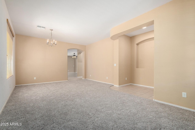 15588 W Devonshire Ave, Goodyear, AZ 85395 - carpeted empty room featuring arched walkways and a chandelier