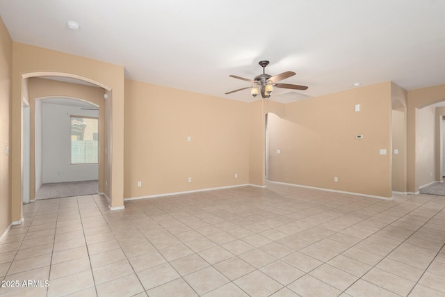 15588 W Devonshire Ave, Goodyear, AZ 85395 - spare room with arched walkways, a ceiling fan, light tile patterned floors, and a smoke detector