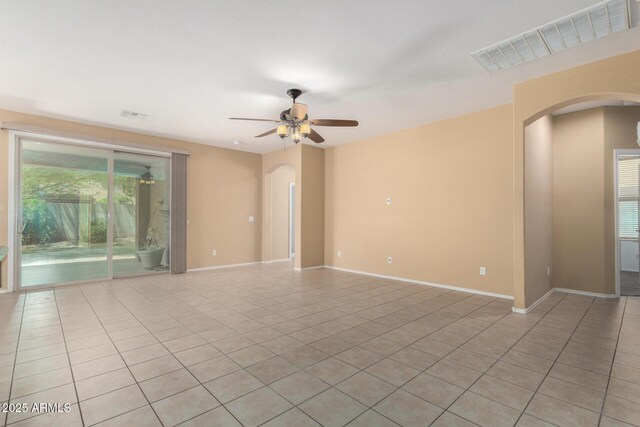 15588 W Devonshire Ave, Goodyear, AZ 85395 - empty room featuring arched walkways, light tile patterned flooring, and ceiling fan