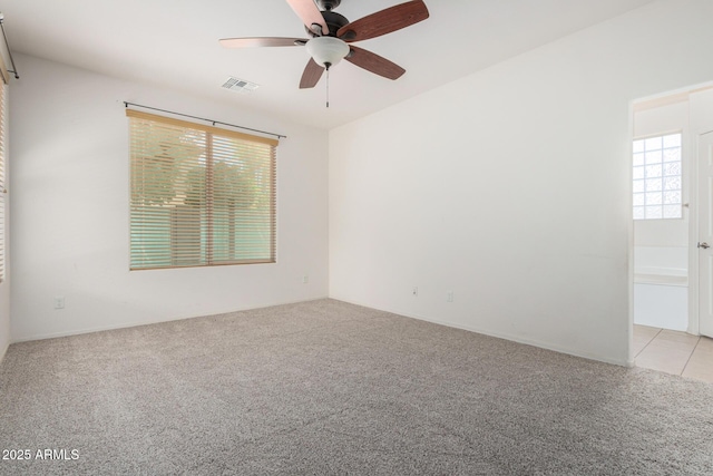 15588 W Devonshire Ave, Goodyear, AZ 85395 - spare room with light colored carpet, plenty of natural light, and ceiling fan