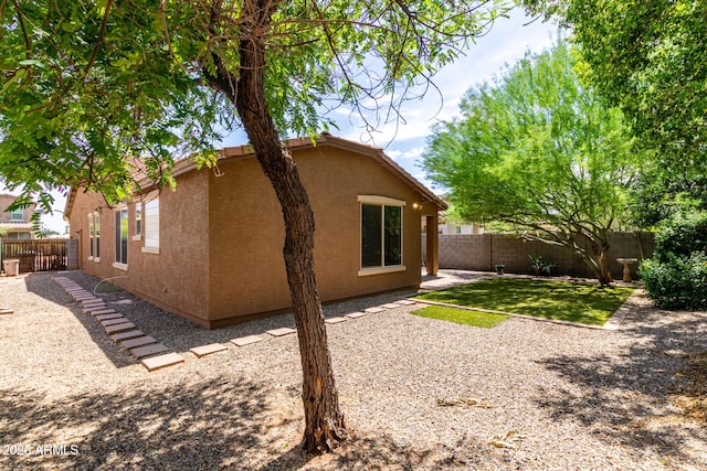 15588 W Devonshire Ave, Goodyear, AZ 85395 - view of side of property featuring a fenced backyard, stucco siding, and a patio