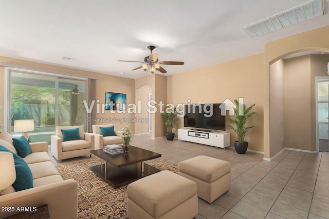 15588 W Devonshire Ave, Goodyear, AZ 85395 - tiled living area with arched walkways and ceiling fan