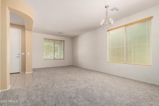 15588 W Devonshire Ave, Goodyear, AZ 85395 - unfurnished room featuring carpet flooring, a chandelier, and tile patterned floors