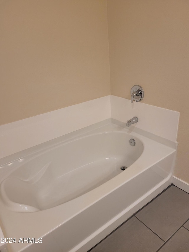 full bathroom featuring a garden tub and tile patterned flooring