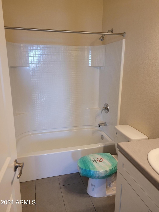 bathroom featuring toilet,  shower combination, vanity, and tile patterned floors