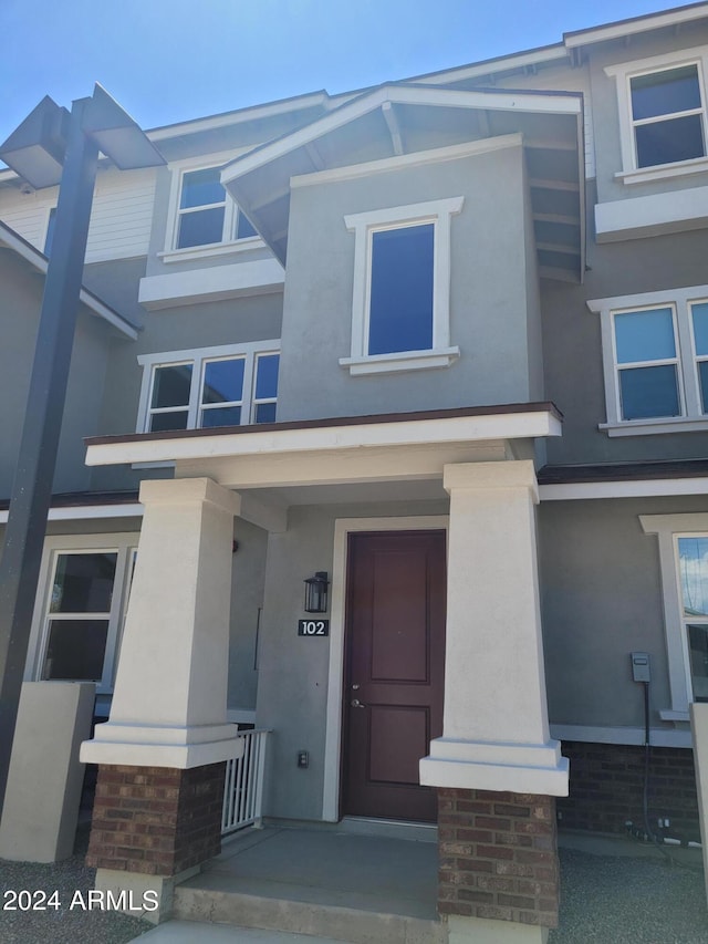 view of front of house with a porch and stucco siding