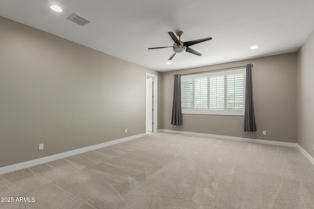 unfurnished room featuring light carpet, a ceiling fan, visible vents, and baseboards