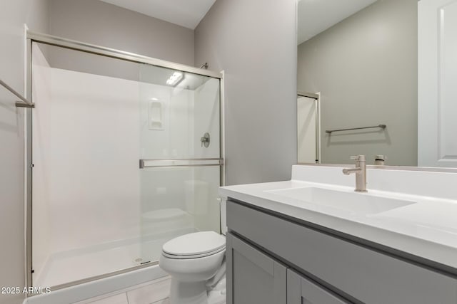 bathroom with vanity, toilet, and a stall shower