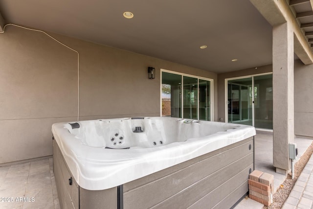 view of patio / terrace with a hot tub