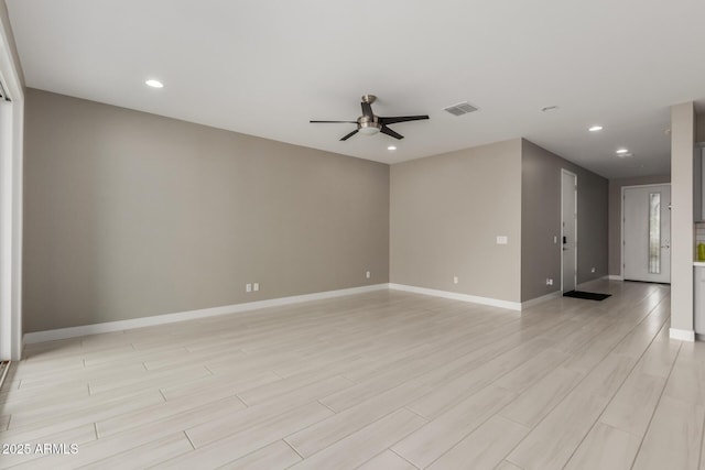 empty room with recessed lighting, a ceiling fan, visible vents, and baseboards