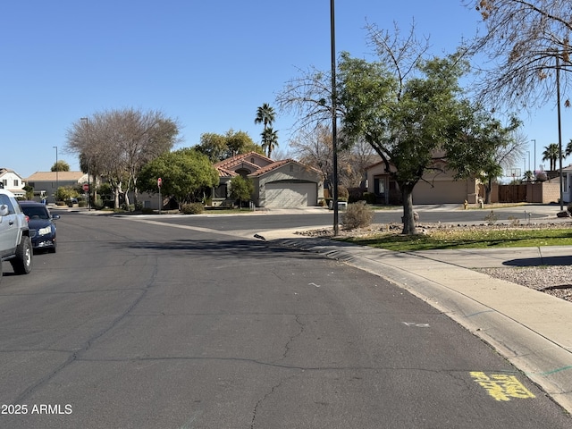 view of street featuring sidewalks, a residential view, and curbs