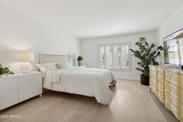 bedroom featuring light hardwood / wood-style floors and multiple windows