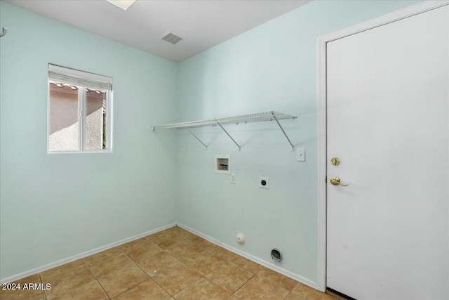 laundry room featuring electric dryer hookup, gas dryer hookup, hookup for a washing machine, and light tile patterned floors