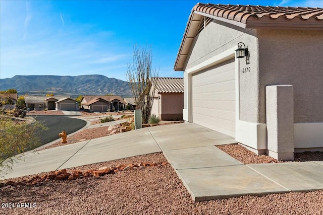 exterior space with a mountain view and a garage