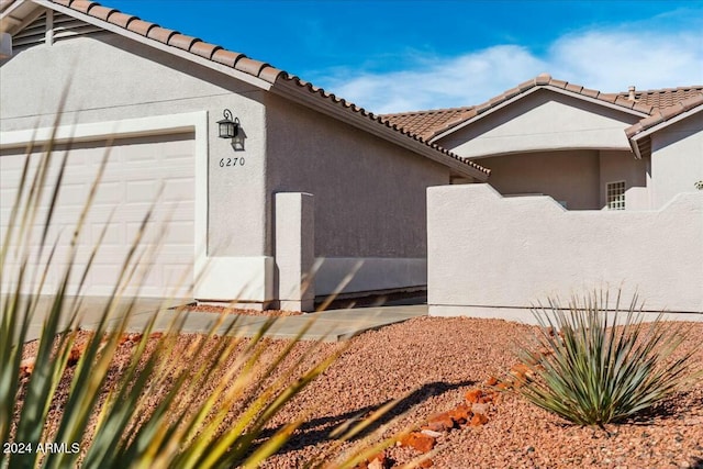 view of side of home featuring a garage