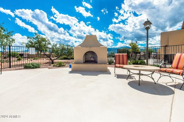 view of patio / terrace featuring exterior fireplace