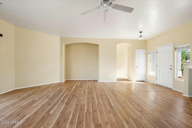 unfurnished living room with ceiling fan and light wood-type flooring