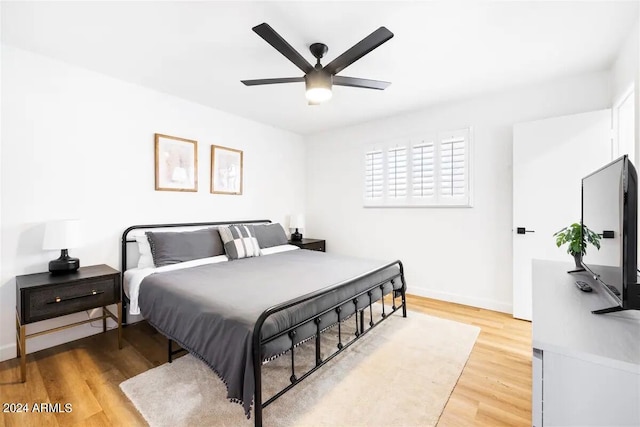 bedroom with ceiling fan and hardwood / wood-style floors