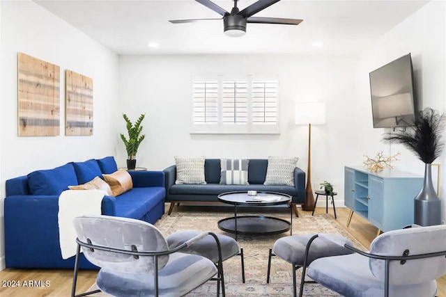 living room featuring ceiling fan and wood-type flooring