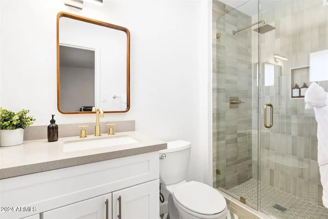 bathroom featuring an enclosed shower, toilet, and oversized vanity