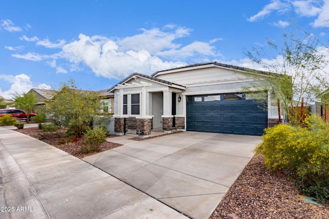 view of front of home with stucco siding, stone siding, concrete driveway, and an attached garage