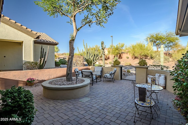 view of patio / terrace featuring a gate and fence