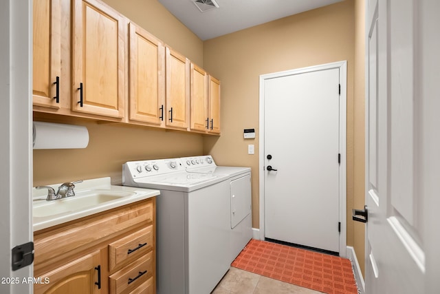 laundry area featuring visible vents, separate washer and dryer, a sink, and cabinet space