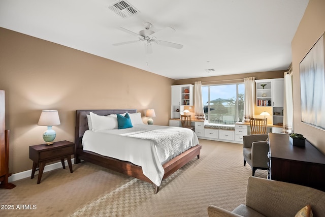 bedroom featuring light colored carpet, visible vents, ceiling fan, and baseboards