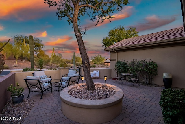 view of patio terrace at dusk