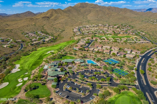 drone / aerial view with view of golf course, a residential view, and a mountain view