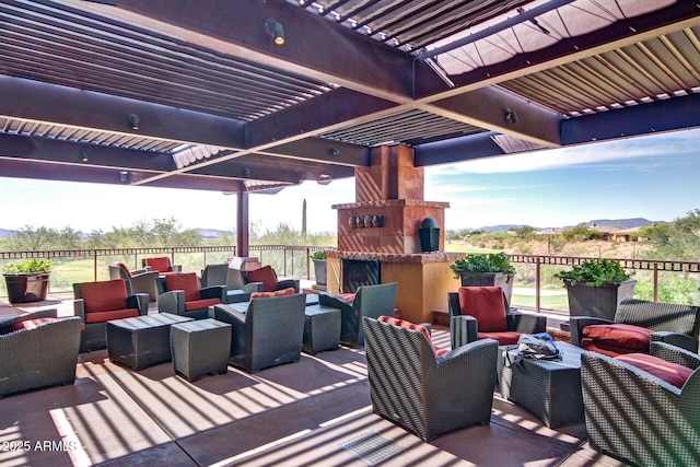 view of patio / terrace with an outdoor living space with a fireplace, a mountain view, and a pergola