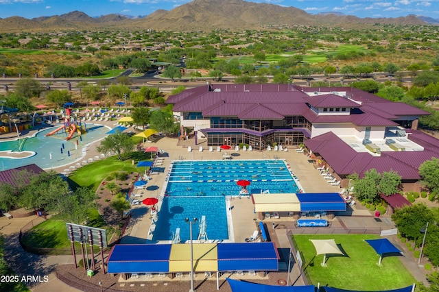 view of swimming pool with a mountain view