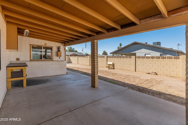 view of patio with a fenced backyard and central AC