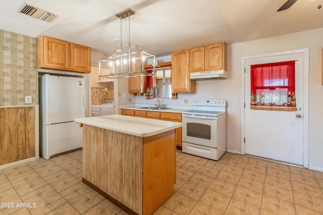 kitchen featuring under cabinet range hood, white appliances, a sink, visible vents, and light countertops