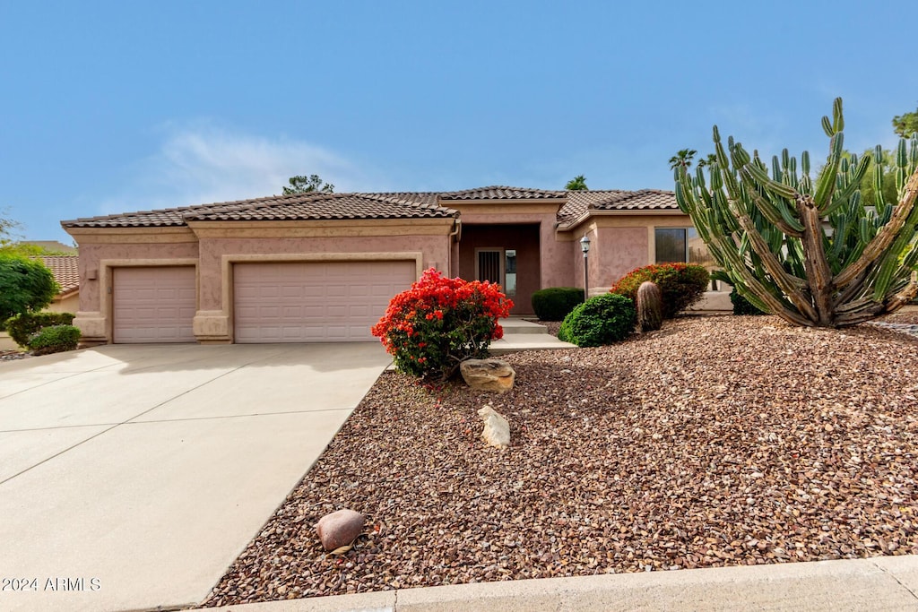 mediterranean / spanish-style home featuring a garage