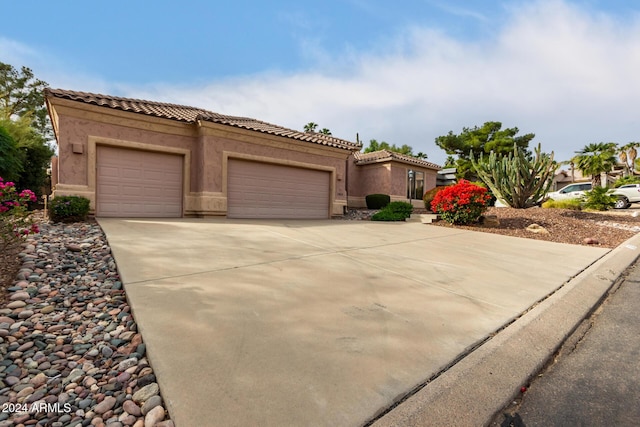 mediterranean / spanish home featuring a garage