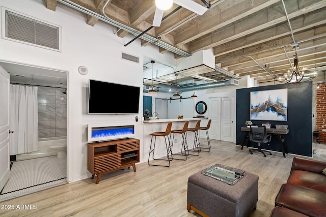 114 W Adams St Unit 202, Phoenix, AZ 85003 - living room featuring light wood-type flooring, an office area, and a ceiling fan