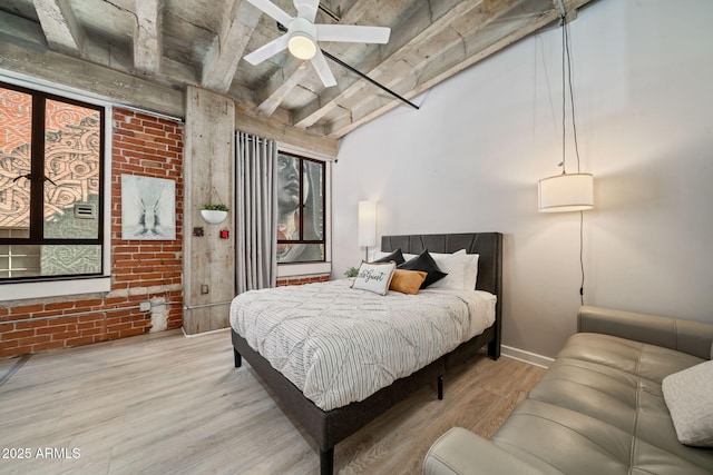 114 W Adams St Unit 202, Phoenix, AZ 85003 - bedroom featuring wood finished floors, brick wall, and beam ceiling