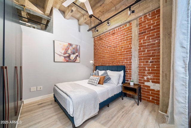 114 W Adams St Unit 202, Phoenix, AZ 85003 - bedroom with light wood-type flooring, brick wall, rail lighting, and a high ceiling
