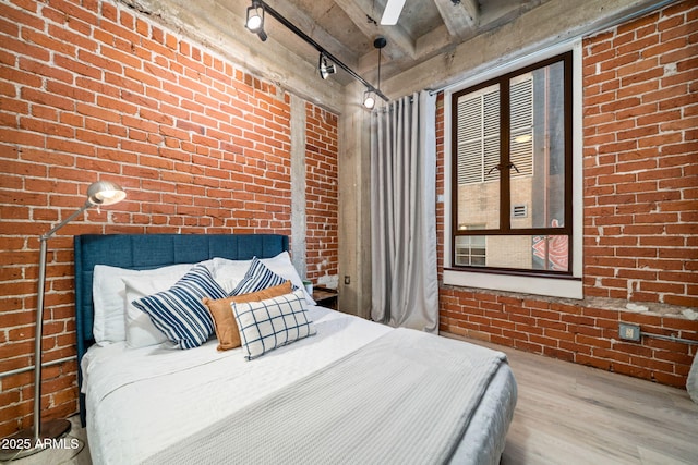 114 W Adams St Unit 202, Phoenix, AZ 85003 - bedroom featuring brick wall and wood finished floors