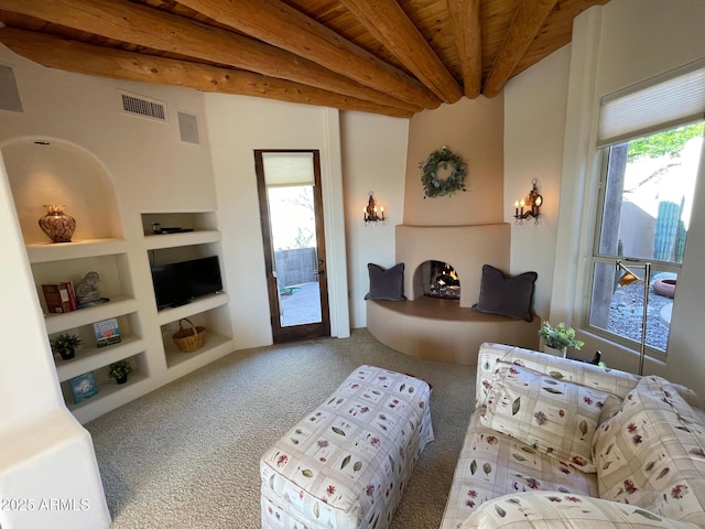 6001 E Restin Rd, Cave Creek, AZ 85331 - living area with built in shelves, beamed ceiling, visible vents, and carpet